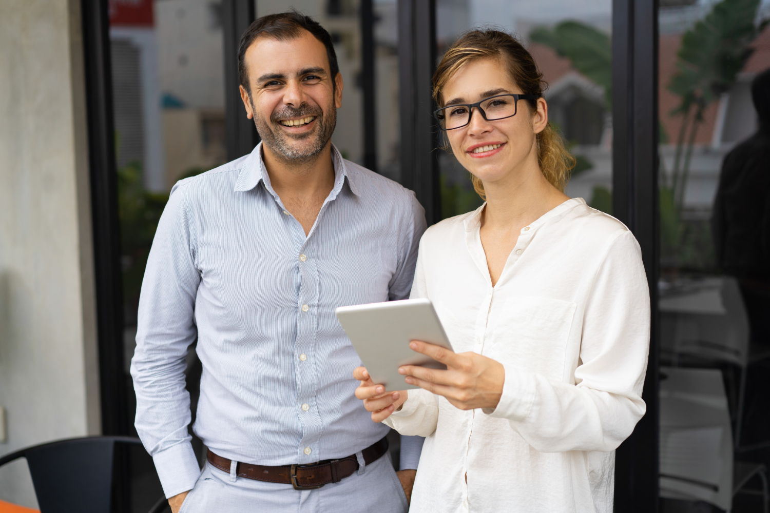 A small business owner reviewing a security report on a tablet.